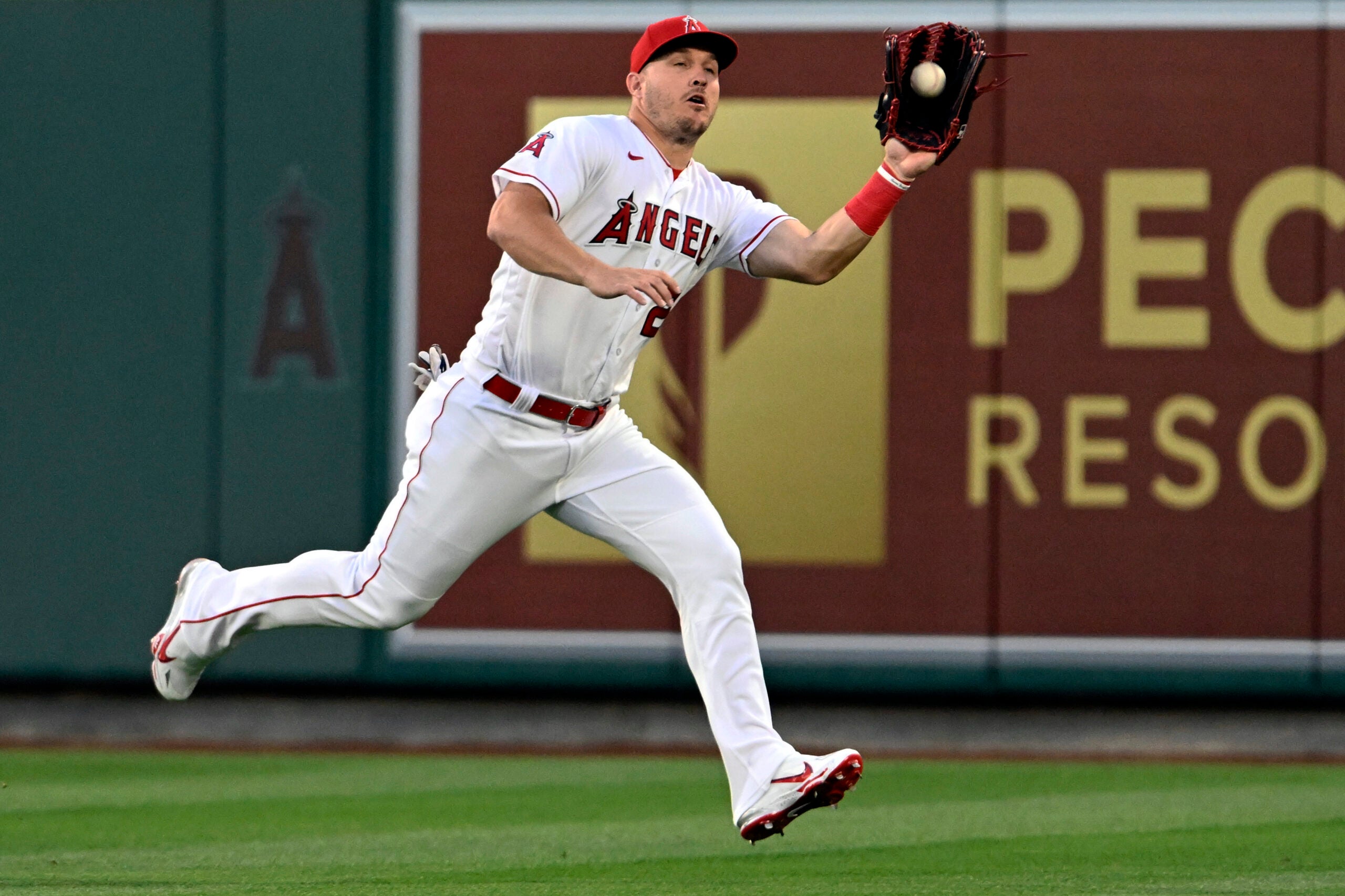 Los Angeles Angels center fielder Mike Trout runs to catch a fly ball hit by Boston Red Sox's Pablo Reyes during the fifth inning.