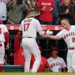 Los Angeles Angels designated hitter Shohei Ohtani (17) is greeted by Mike Trout (27) after hitting a home run during the third inning of a baseball game against the Boston Red Sox.