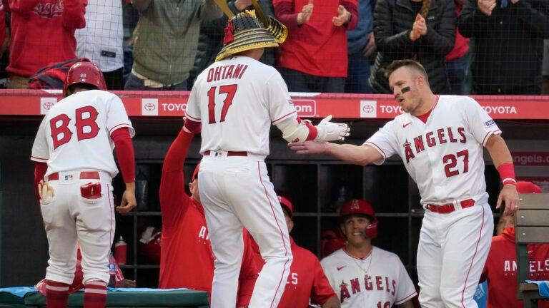 Los Angeles Angels designated hitter Shohei Ohtani (17) is greeted by Mike Trout (27) after hitting a home run during the third inning of a baseball game against the Boston Red Sox.