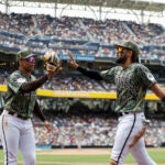 San Diego Padres left fielder Juan Soto and right fielder Fernando Tatis Jr. high-five at the end of the third inning.