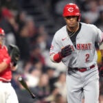 Cincinnati Reds' Jose Barrero (2) tosses his bat while heading down the first base line.