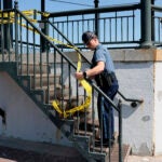 A State trooper puts up yellow tape on the Revere Beach bandstand.
