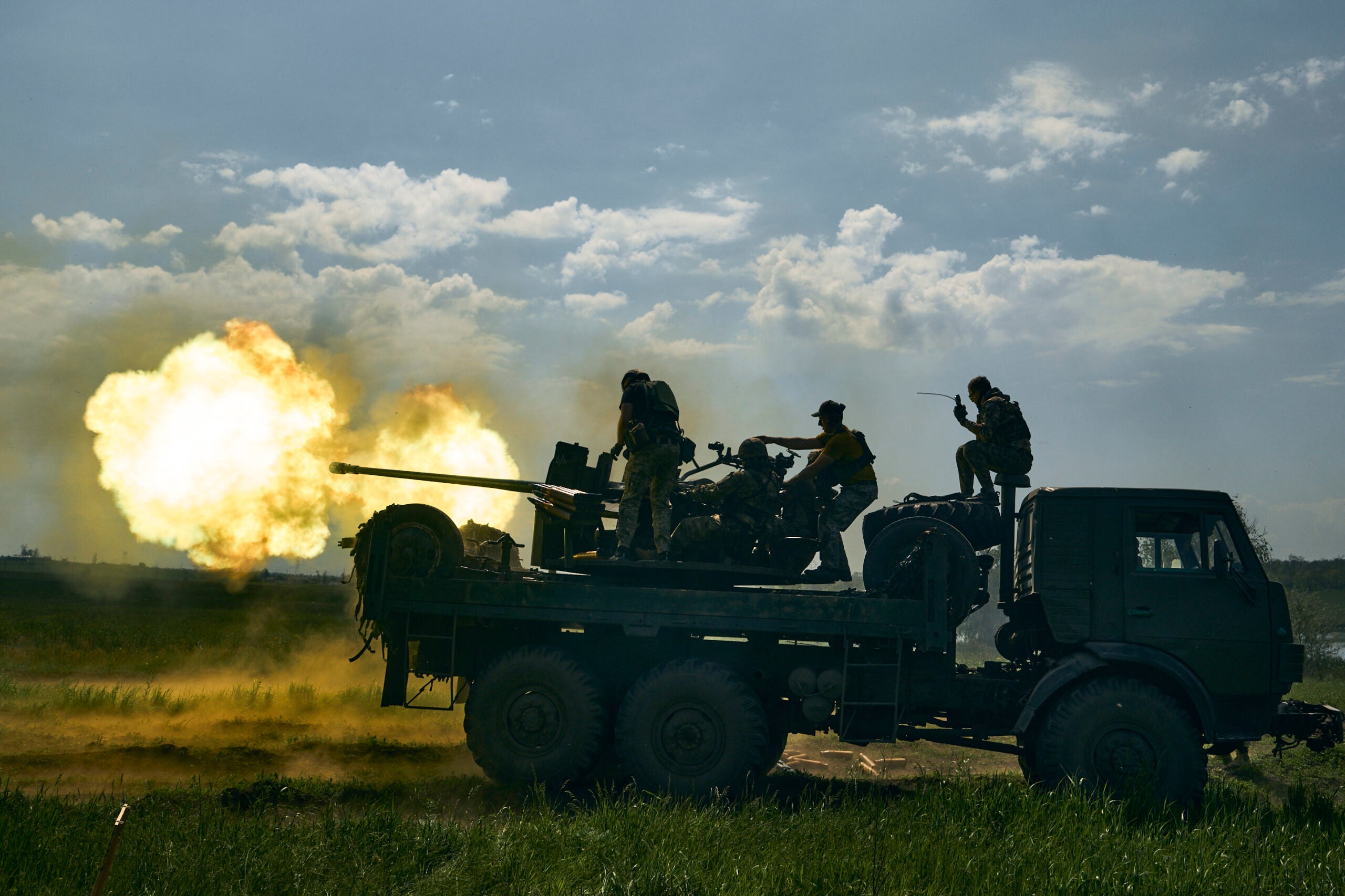 Ukrainian soldiers fire a cannon near Bakhmut