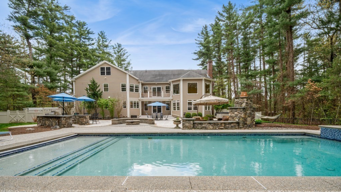 Colonial home with backyard patio and in-ground patio.