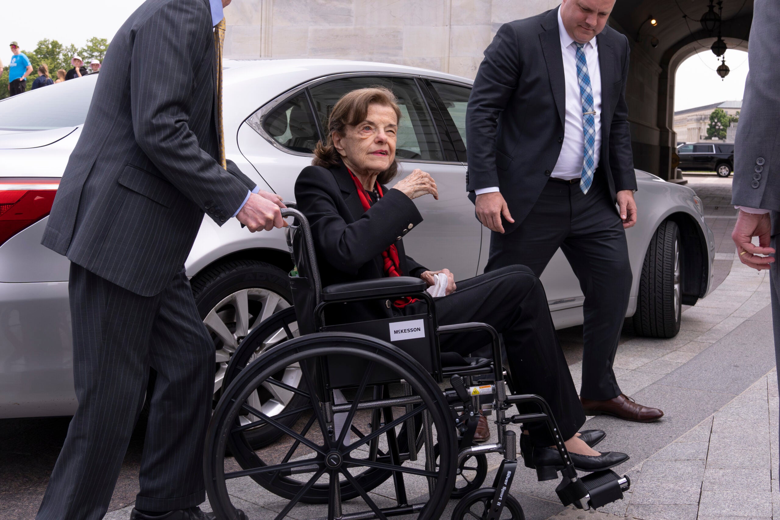 FILE - Sen. Dianne Feinstein, D-Calif., is assisted to a wheelchair by staff as she returns to the Senate after a more than two-month absence