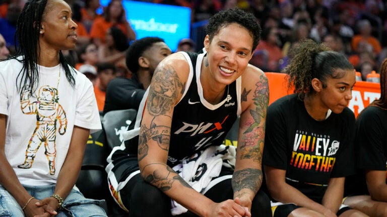 Phoenix Mercury center Brittney Griner smiles at the fans as she sits between Mercury's Shey Peddy, left, and Evina Westbrook, right.