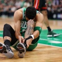 Jayson Tatum #0 of the Boston Celtics grabs his ankle during the first quarter against the Miami Heat in game seven of the Eastern Conference Finals at TD Garden on May 29, 2023 in Boston, Massachusetts.