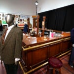 The bar used on the set of the television series "Cheers" and some costumes worn by actors on the sitcom are shown.