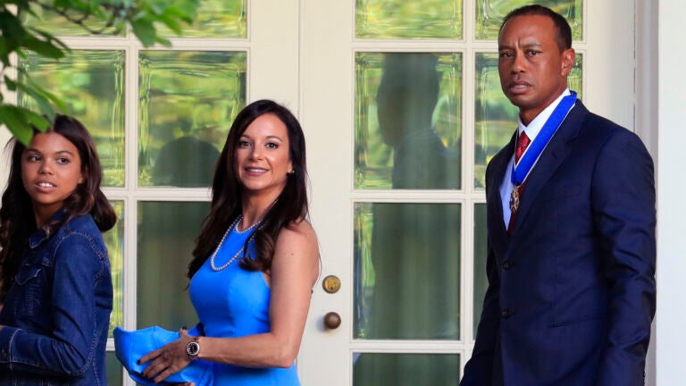 Tiger Woods, right, with his daughter Sam Alexis Woods, left, and his girlfriend Erica Herman, center, walk along the Colonnade following a ceremony where President Donald Trump awarded the Presidential Medal of Freedom to Tiger Woods at the White House in Washington, on May 6, 2019.