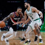 Portland Trail Blazers forward Damian Lillard, left, drives to the basket against Boston Celtics forward Jayson Tatum during the second half of an NBA basketball game, Wednesday, March 8, 2023, in Boston.