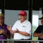 Former President Donald Trump stands next to Greg Norman, LIV Golf CEO, right, and Paul Myler, deputy head of mission for the Australian Embassy in Washington, left.