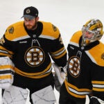 Boston Bruins goaltender Linus Ullmark (35) (left) and Boston Bruins goaltender Jeremy Swayman (1) skate to the line to shake hands of Florida players at the end of their overtime loss.