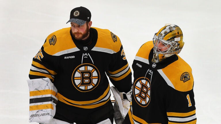 Boston Bruins goaltender Linus Ullmark (35) (left) and Boston Bruins goaltender Jeremy Swayman (1) skate to the line to shake hands of Florida players at the end of their overtime loss.