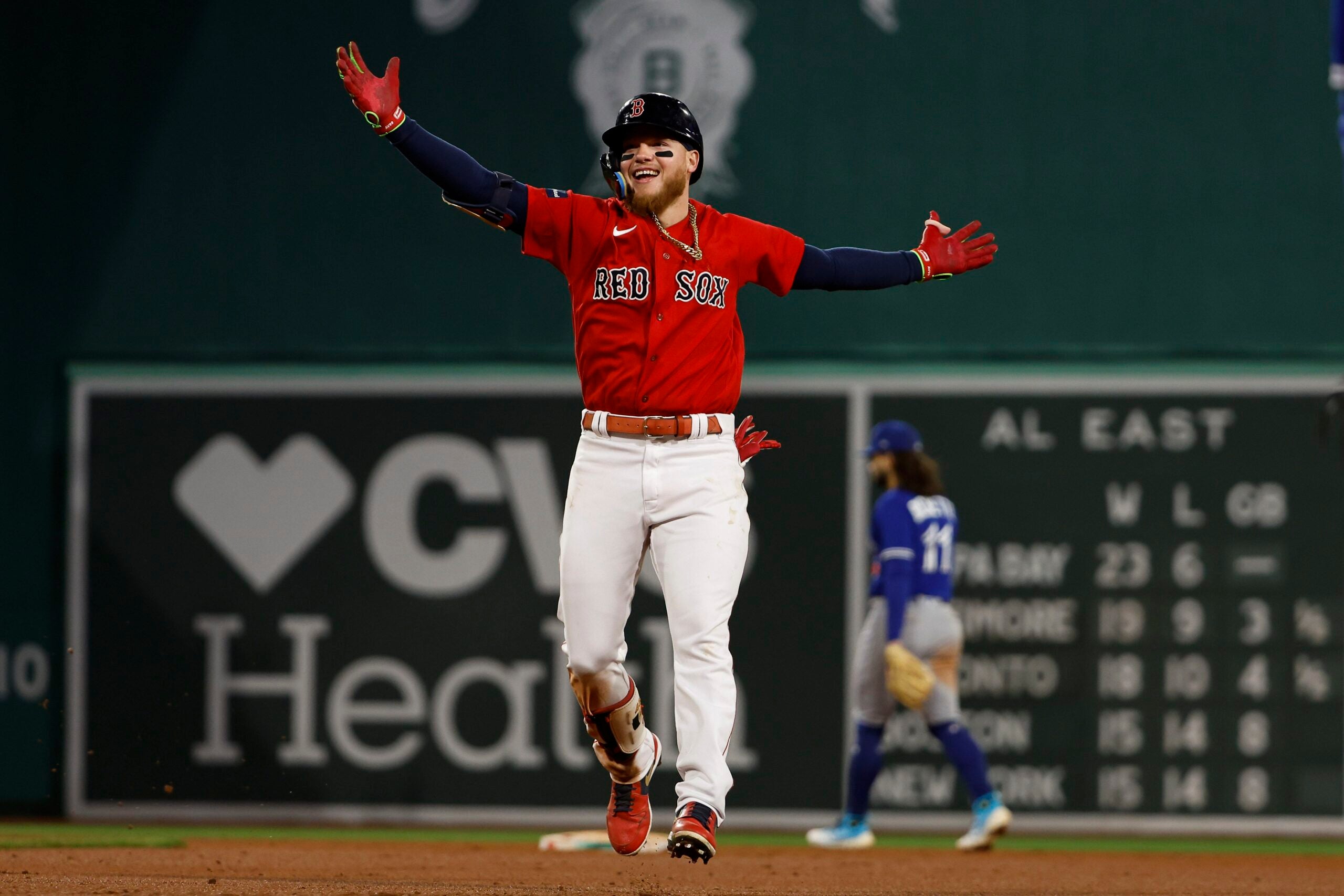 Alex Verdugo #99 of the Boston Red Sox celebrates his walk-off home run as Bo Bichette #11 of the Toronto Blue Jays heads for the clubhouse during the ninth inning at Fenway Park on May 1, 2023 in Boston, Massachusetts.