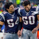 Patriots linebacker Mike Vrabel (50,right) who had two interceptions in the game, including one on the last play Detroit ran in the game that sealed the victory, gets a pat on the head from fellow linebacker Tedy Bruschi (left) after the game.