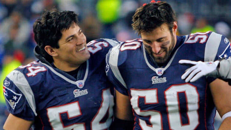 Patriots linebacker Mike Vrabel (50,right) who had two interceptions in the game, including one on the last play Detroit ran in the game that sealed the victory, gets a pat on the head from fellow linebacker Tedy Bruschi (left) after the game.