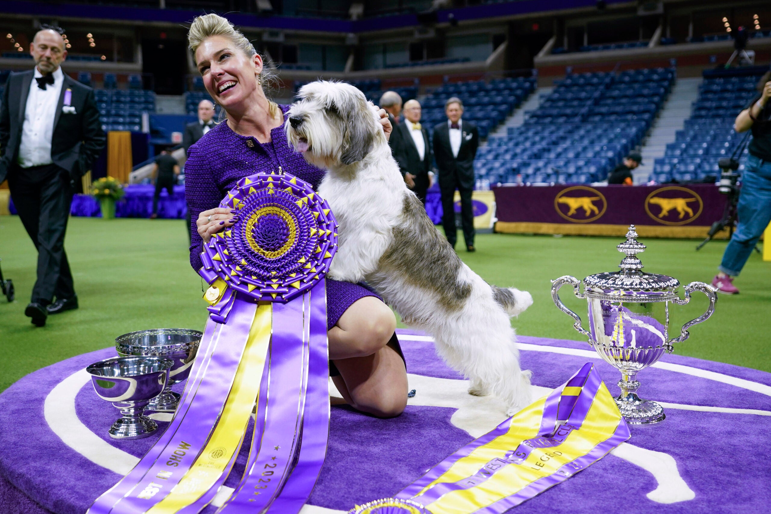 Handler Janice Hays poses for photos with Buddy Holly, a petit basset griffon Vendéen, after he won best in show during the 147th Westminster Kennel Club Dog show, Tuesday, May 9, 2023, at the USTA Billie Jean King National Tennis Center in New York.