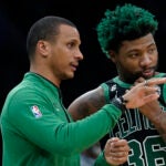 Boston Celtics interim head coach Joe Mazzulla, left, speaks with guard Marcus Smart, right, in the first half of an NBA basketball game against the Washington Wizards, Sunday, Oct. 30, 2022, in Boston.