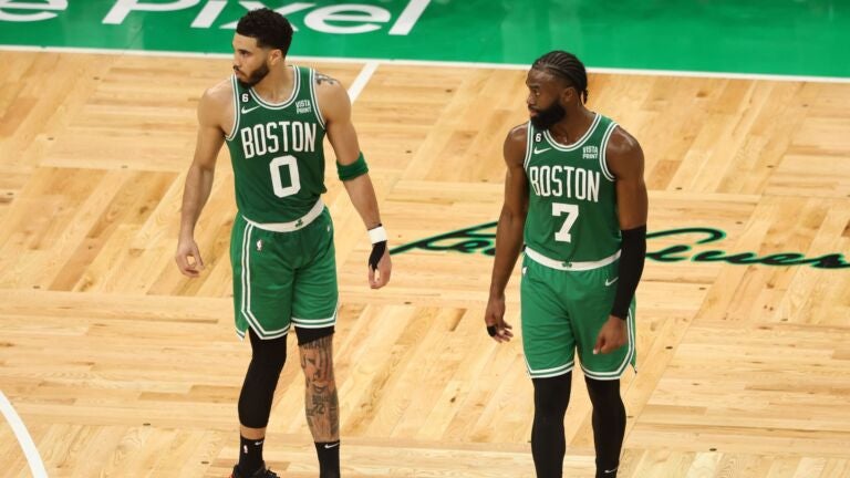Celtics forward Jayson Tatum standing to the left of Jaylen Brown on the court at TD Garden.
