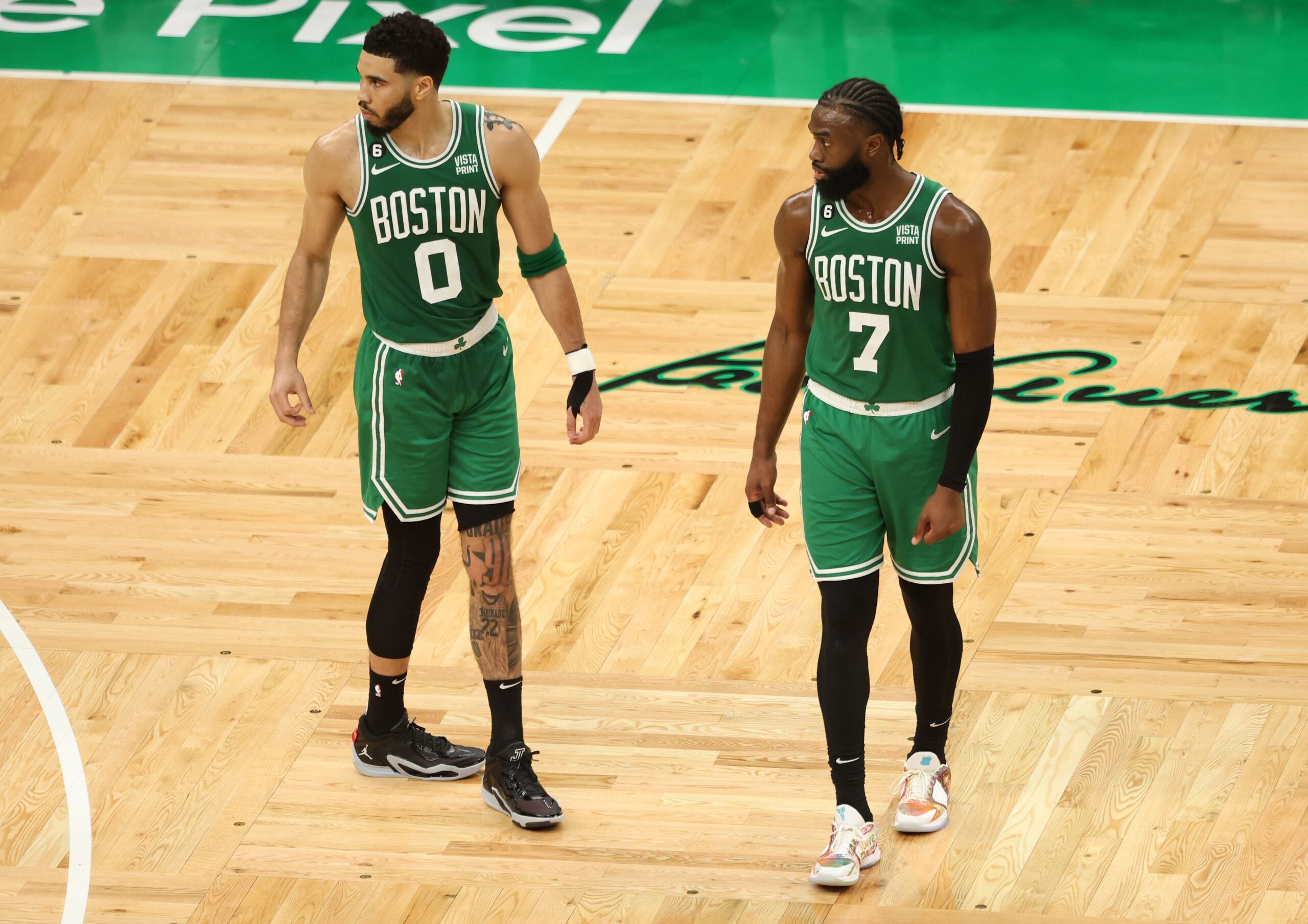 Celtics forward Jayson Tatum standing to the left of Jaylen Brown on the court at TD Garden.
