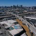 An aerial image taken on Feb. 8, 2023, shows vehicles driving across the 6th Street Viaduct toward the downtown Los Angeles skyline.