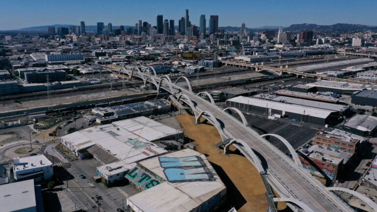 An aerial image taken on Feb. 8, 2023, shows vehicles driving across the 6th Street Viaduct toward the downtown Los Angeles skyline.