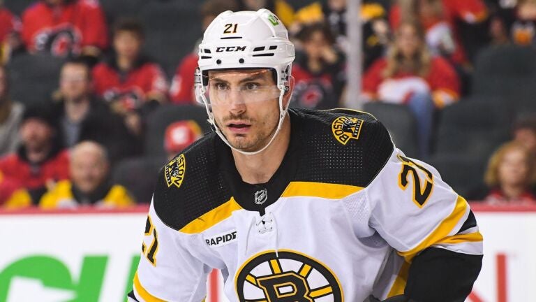 Garnet Hathaway #21 of the Boston Bruins lines up for a face-off against the Calgary Flames during the first period of an NHL game at Scotiabank Saddledome on February 28, 2023 in Calgary, Alberta, Canada.