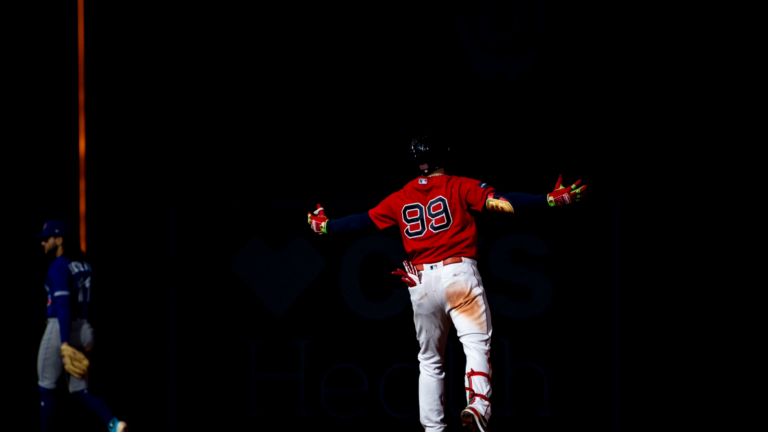 Red Sox outfielder Alex Verdugo stands in the dark around second base after kitting a home run.