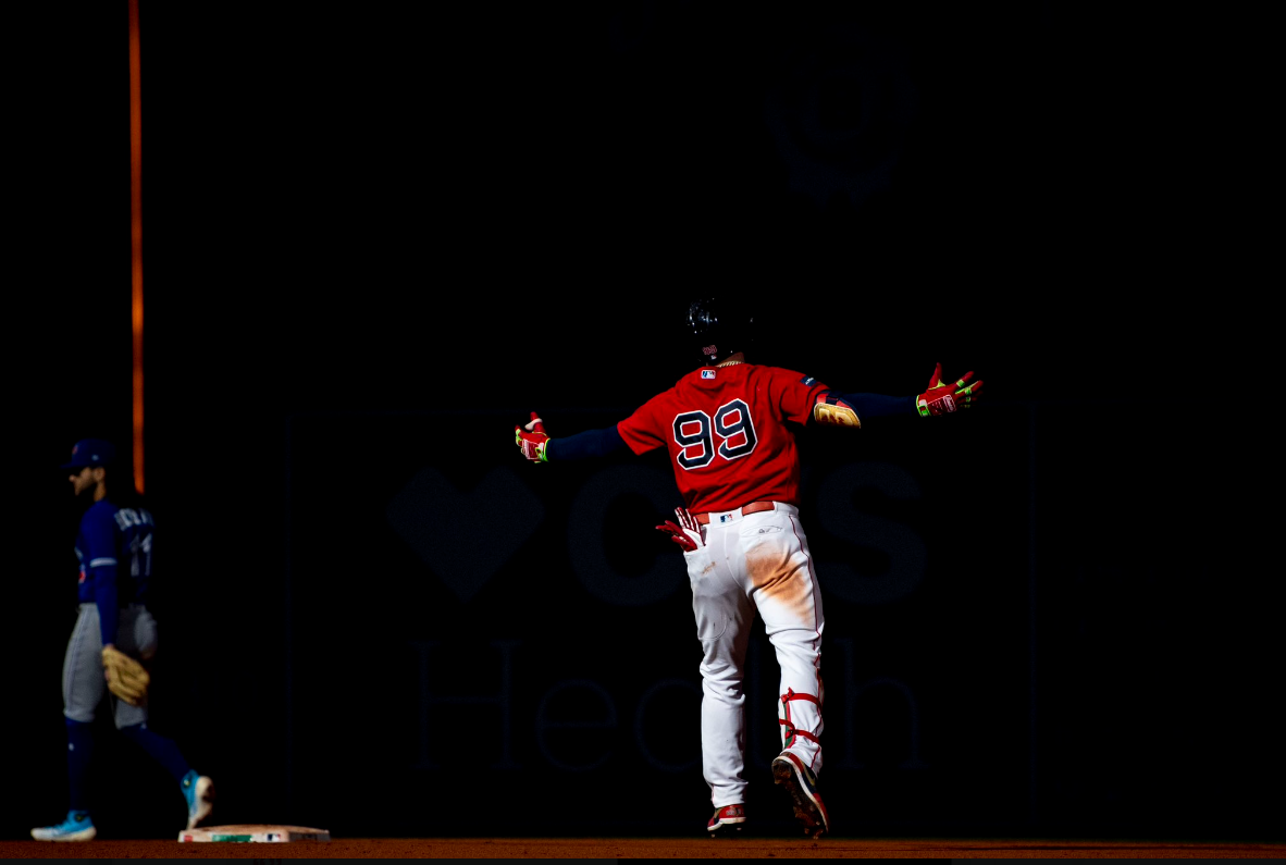 Red Sox outfielder Alex Verdugo stands in the dark around second base after kitting a home run.