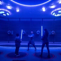 Passengers learn the ancient art of wielding a lightsaber in the Lightsaber Training Pod onboard the Halcyon starcruiser in Star Wars: Galactic Starcruiser at Walt Disney World Resort in Lake Buena Vista, Fla.