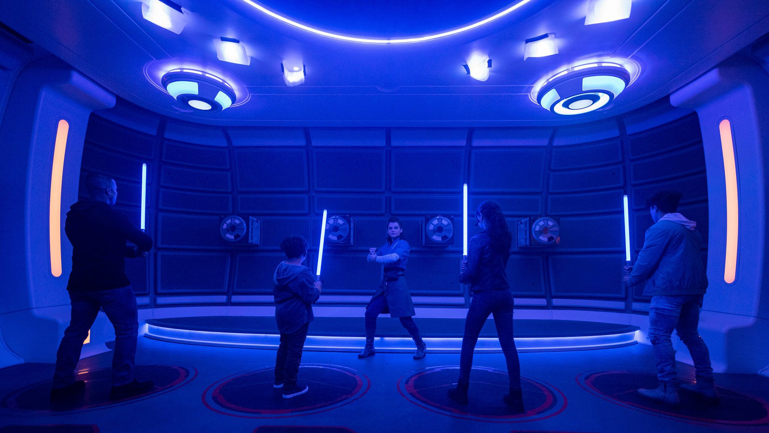 Passengers learn the ancient art of wielding a lightsaber in the Lightsaber Training Pod onboard the Halcyon starcruiser in Star Wars: Galactic Starcruiser at Walt Disney World Resort in Lake Buena Vista, Fla.
