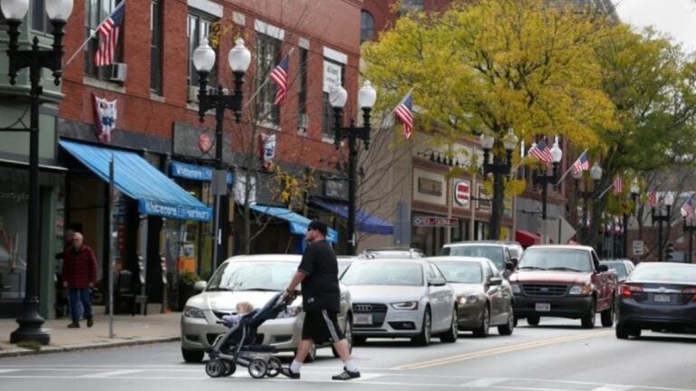 A man pushes a stroller in a crosswalk in downtown Melrose in a photo used to illustrate the rental market in Massachusetts.
