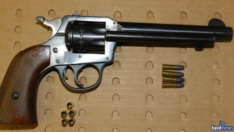 A large revolver and several rounds of ammunition.