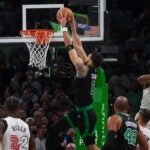 Boston Celtics forward Jayson Tatum drives for a running dunk against the Heat.