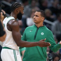 Joe Mazzulla (right) and Jaylen Brown (left) have an animated conversation on the sideline of a Celtics game.