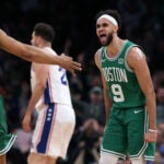 After the Celtics Malcolm Brogdon (13,left) hit a three pointer during their third quarter barrage, teammate Derrick White (right) howled with delight.