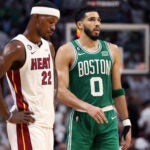 Miami's Jimmy Butler (left) and the Celtics Jayson Tatum (right) are pictured during a late fourth quarter free throw by Boston.