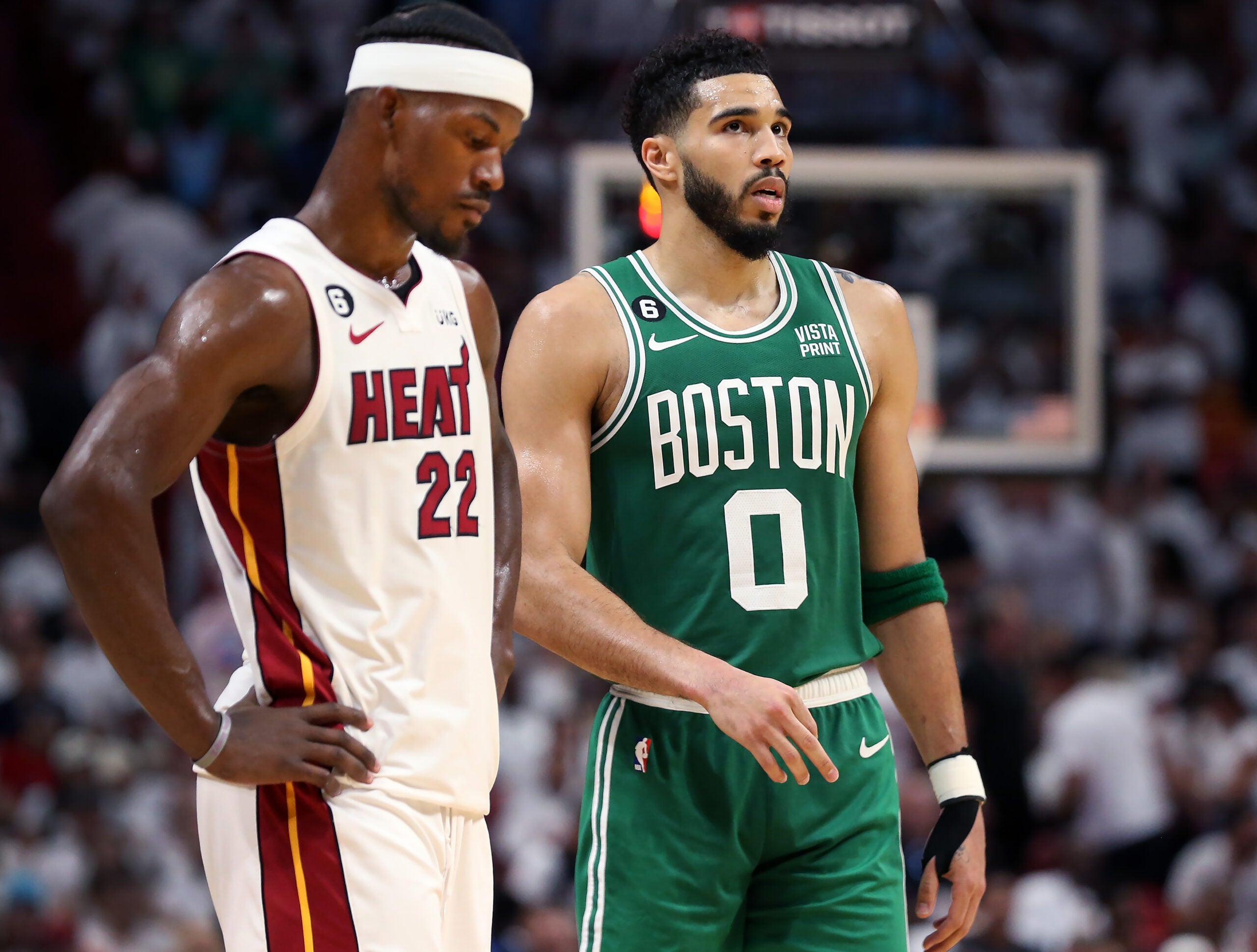 Miami's Jimmy Butler (left) and the Celtics Jayson Tatum (right) are pictured during a late fourth quarter free throw by Boston.