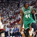 The Celtics Robert Williams (right) howls after he slammed home two fourth quarter points, Miami's Kyle Lowry is at left. The Boston Celtics visited the Miami Heat for Game Four of their NBA Eastern Conference Finals series at the Kaseya Center.