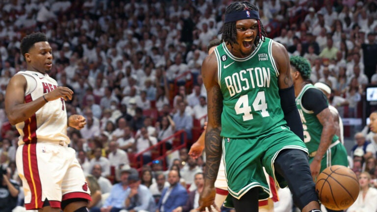 The Celtics Robert Williams (right) howls after he slammed home two fourth quarter points, Miami's Kyle Lowry is at left. The Boston Celtics visited the Miami Heat for Game Four of their NBA Eastern Conference Finals series at the Kaseya Center.