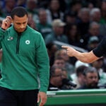 A referee signals that Celtics head coach Joe Mazzulla (left) has just called for a first quarter time out. The Boston Celtics hosted the Philadelphia 76ers for Game Five of their NBA Eastern Conference Semi Final basketball series at the TD Garden.