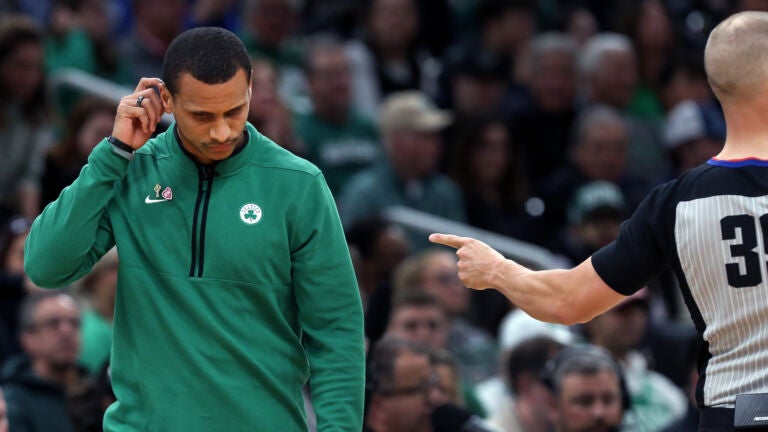 A referee signals that Celtics head coach Joe Mazzulla (left) has just called for a first quarter time out. The Boston Celtics hosted the Philadelphia 76ers for Game Five of their NBA Eastern Conference Semi Final basketball series at the TD Garden.