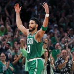 Jayson Tatum acknowledges and encourages the cheers of the crowd as he leaves the game in the fourth quarter.