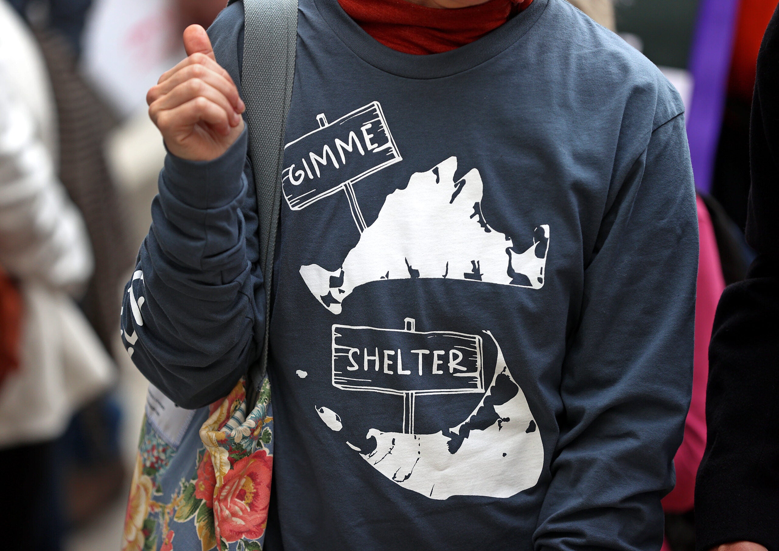 Stephanie Mashek, of Martha's Vineyard, wears a "Gimme Shelter" shirt as advocates from the island marched to the State House in March. 