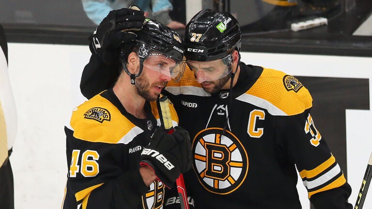 Boston -04/30/2023 Boston Bruins vs Florida Panthers-Game 7 - A teary-eyed David krejci(left) is hugged by Boston Bruins center Patrice Bergeron (37) at the end of their overtime loss.