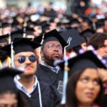 A group of graduates wearing caps and gowns