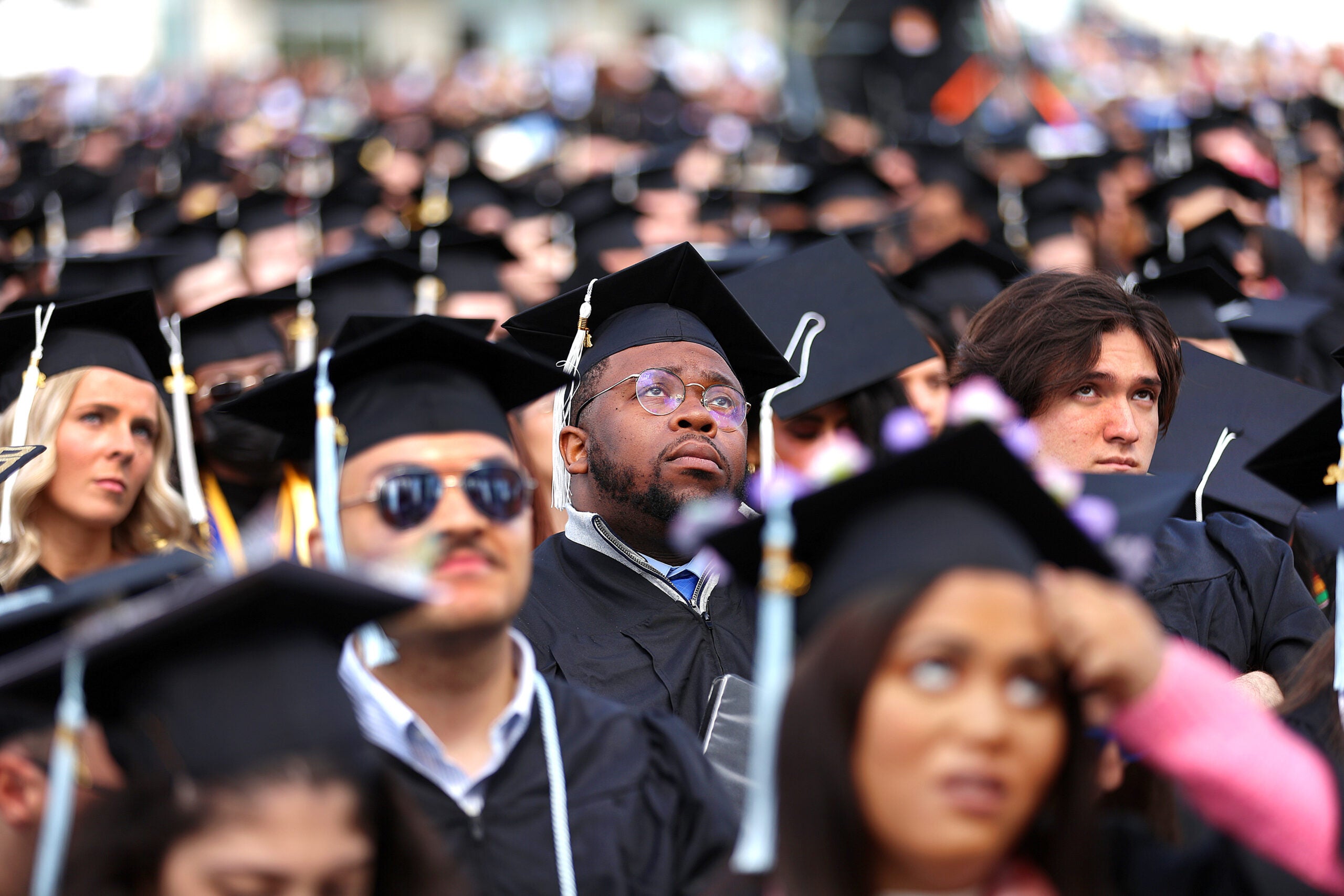 A group of graduates wearing caps and gowns
