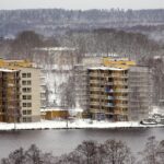 timber-frame construction of a multi-story building is show to discuss climate change and greener building practices.