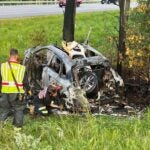 Firefighters investigate the scene of a fiery car crash on I-93 in New Hampshire.