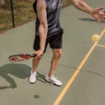 A player serves during a pickleball play at the Walter Reed Community Center.